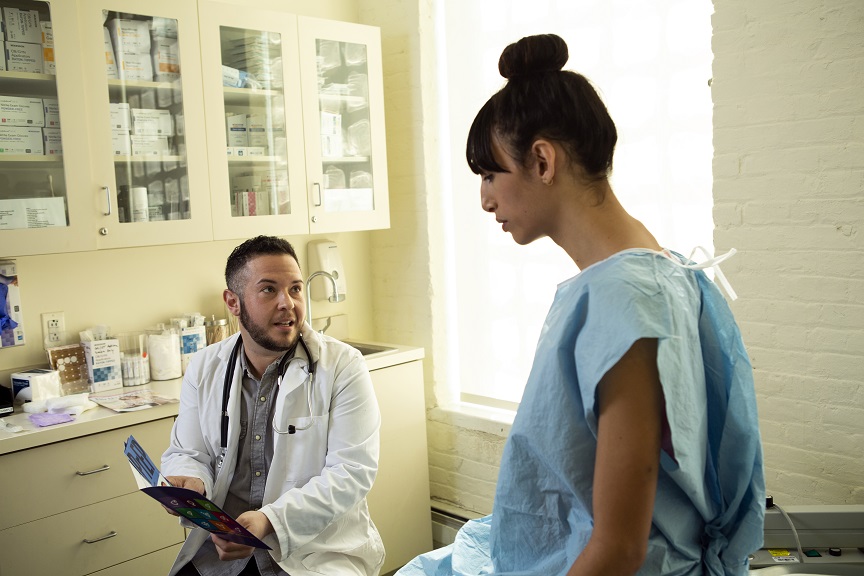 A trans patient in a doctors office with a transgender doctor.