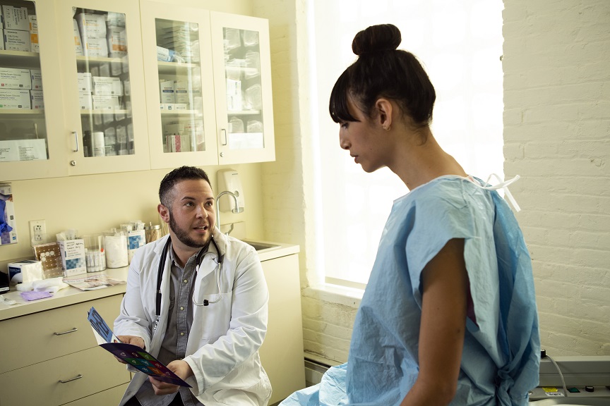 A trans woman in a doctors office with a trans doctor.